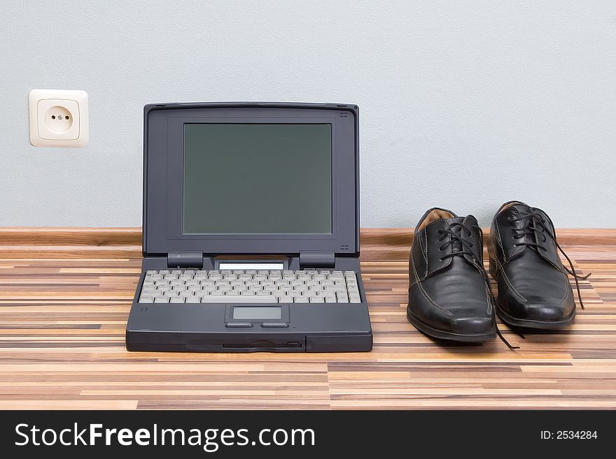 Laptop, shoes, and power outlet