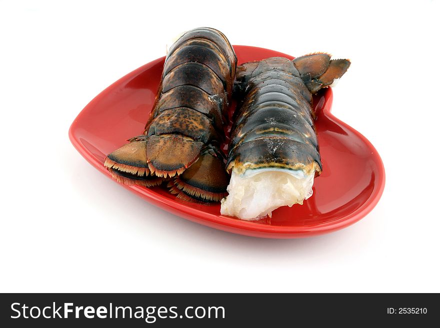 Two lobsters presented on a red plate. Two lobsters presented on a red plate