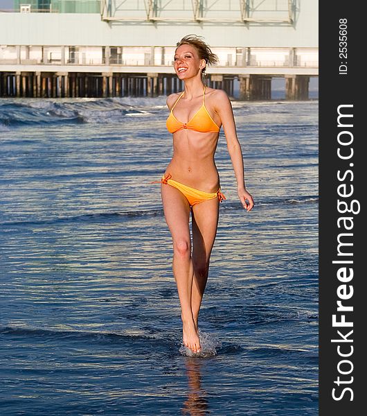 Young lady running in the water. Young lady running in the water
