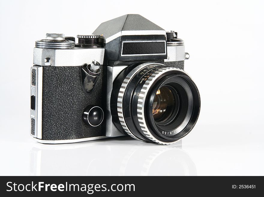 Old reflex camera Praktica super TL on light gray background