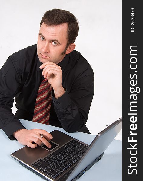 Businessman dressed in suit working on laptop