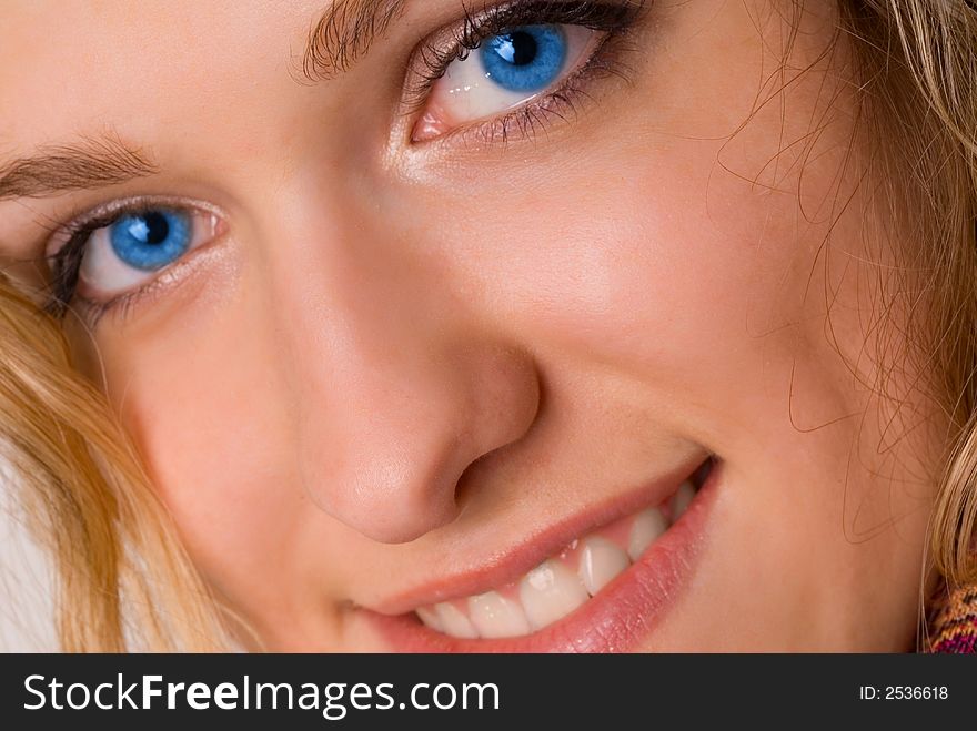 Attractive blue-eyed young woman smiling. Attractive blue-eyed young woman smiling