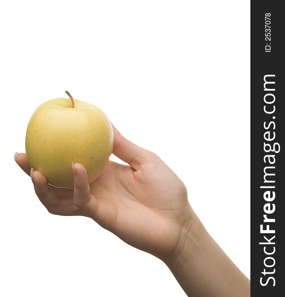 Hand holding a yellow- green apple against a white background. Hand holding a yellow- green apple against a white background.