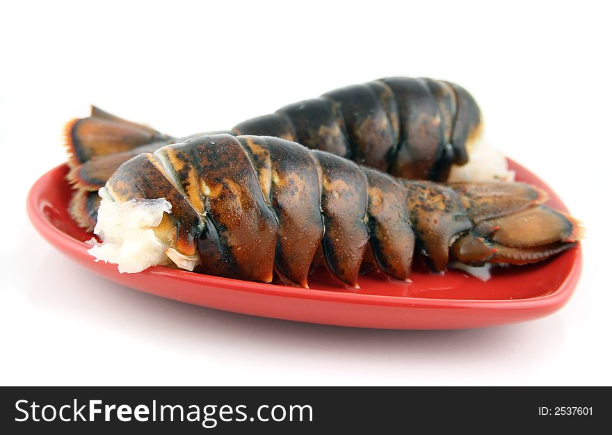 Two lobsters presented on a red plate. Two lobsters presented on a red plate