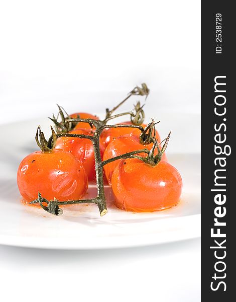 Roasted Cherry Tomatoes on the vine with olive oil, sea salt and black pepper. A delicious start to any meal.