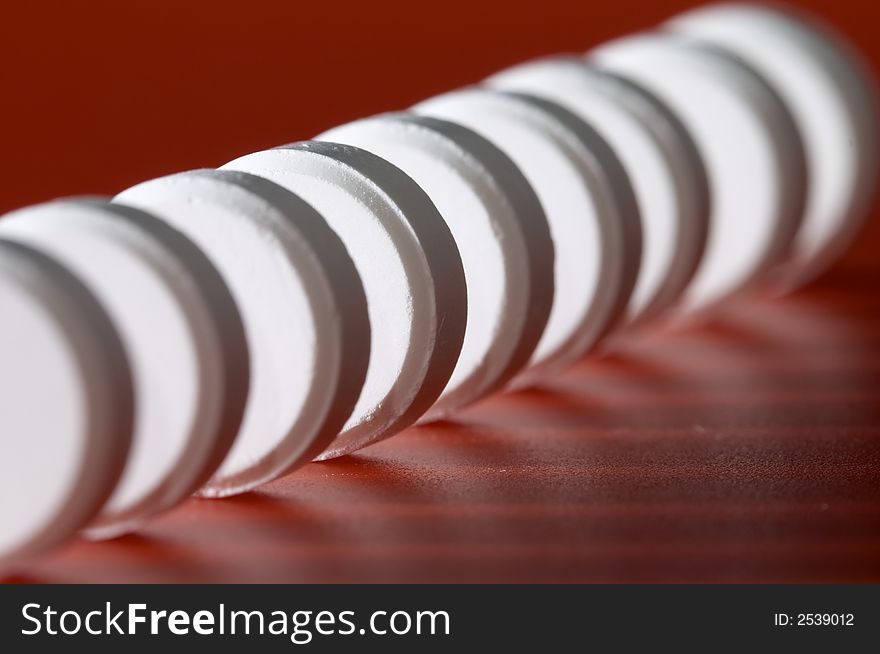 Close-up photo of white pill. Focus on the fourth pill. Shallow DOF. Close-up photo of white pill. Focus on the fourth pill. Shallow DOF