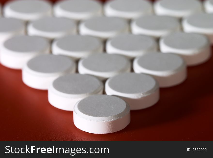 Macro of pills on red background. Shallow DOF. Macro of pills on red background. Shallow DOF