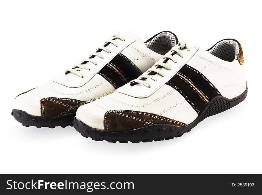 A couple of casual fashionable footwear on a white background with clipping path. A couple of casual fashionable footwear on a white background with clipping path