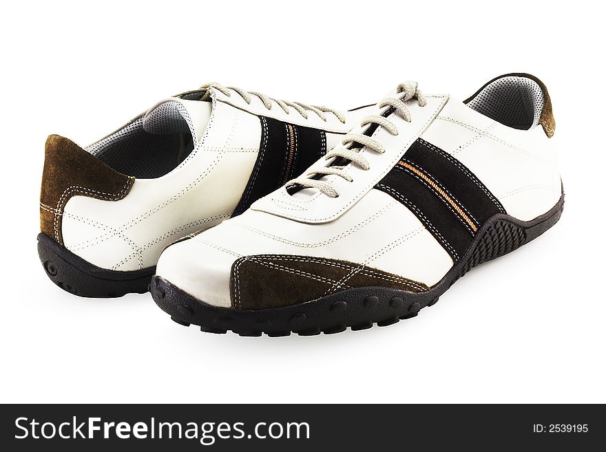 A couple of casual fashionable footwear on a white background with clipping path. A couple of casual fashionable footwear on a white background with clipping path