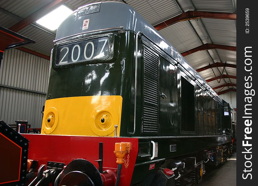 Diesel locomotive in a storage shed all restored for the tracks