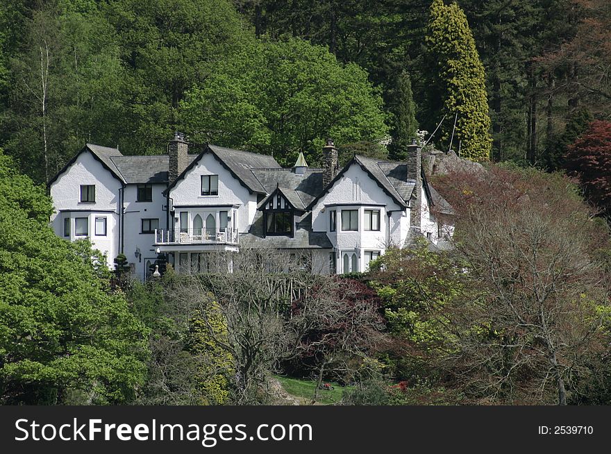 Large white house amongst the trees. Large white house amongst the trees