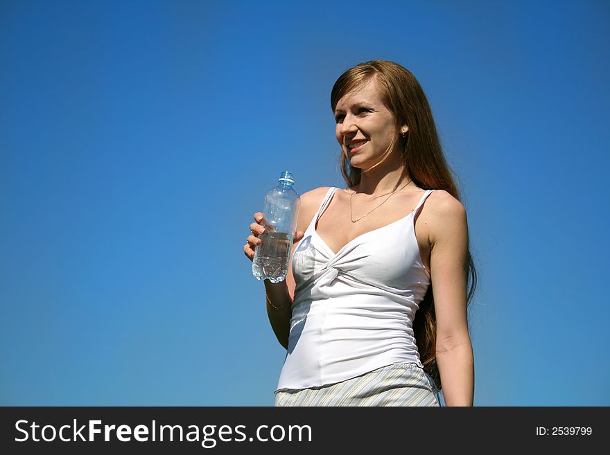 Girl with water on a background of the sky