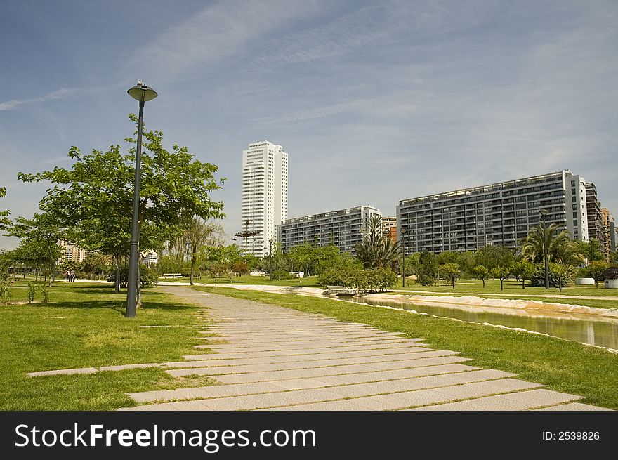 Citypark with skyscraper in the old channel of Turia river in Valencia.