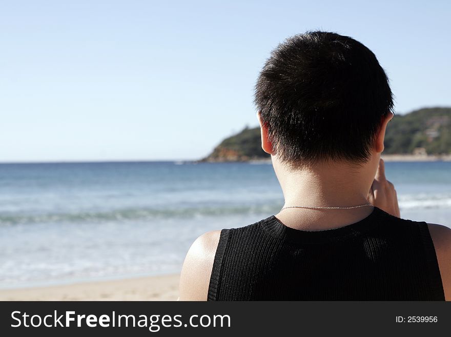 Male Person Standing At The Beach Looking Towards The Ocean, Sydney, Australia. Male Person Standing At The Beach Looking Towards The Ocean, Sydney, Australia