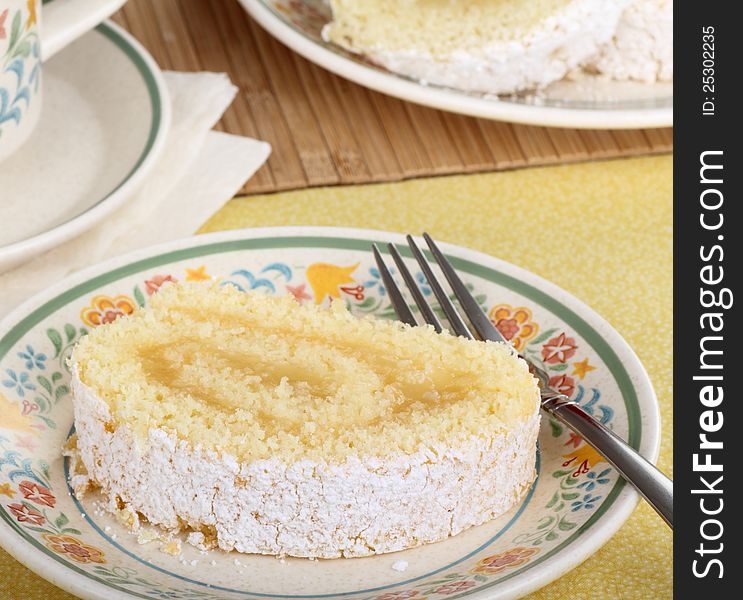 Slice of lemon cake roll on a plate