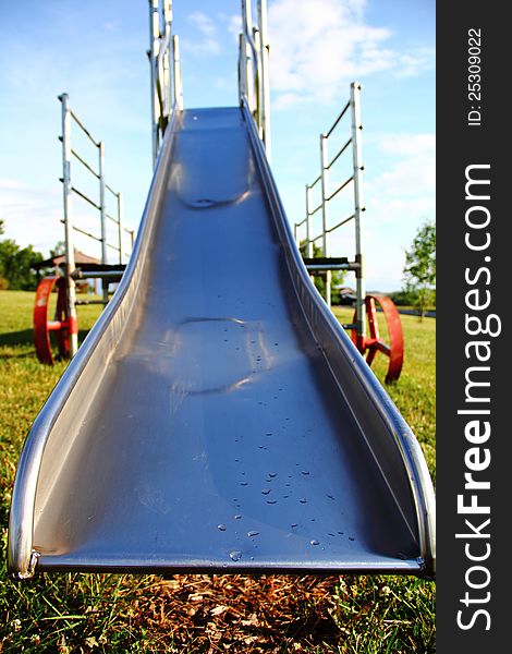 Old metal slide at a playground. Old metal slide at a playground.