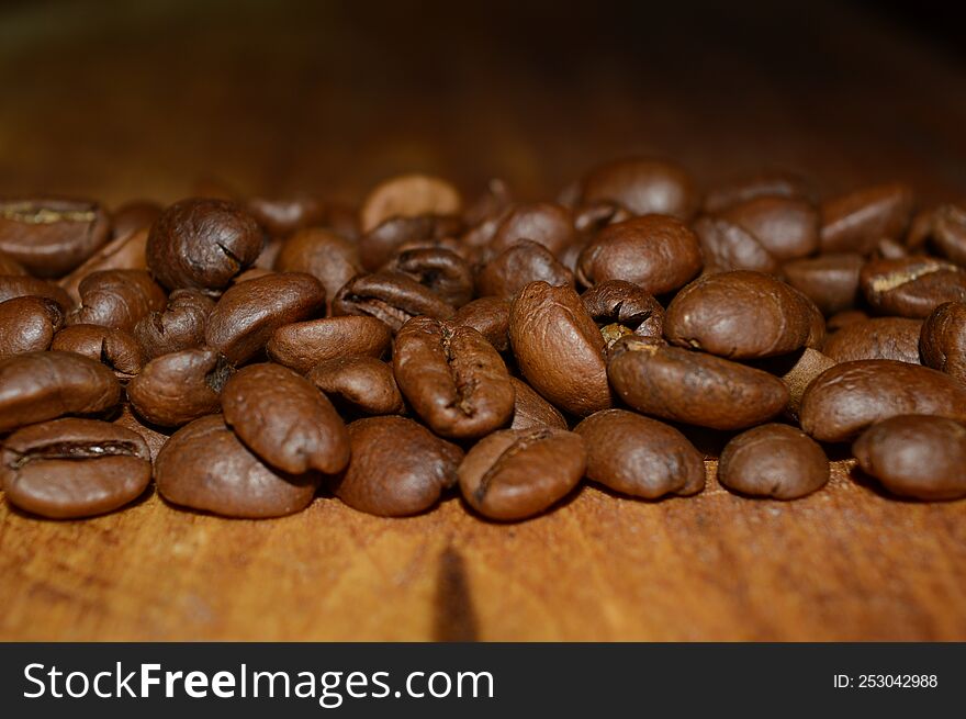 Coffee beans on a woody background