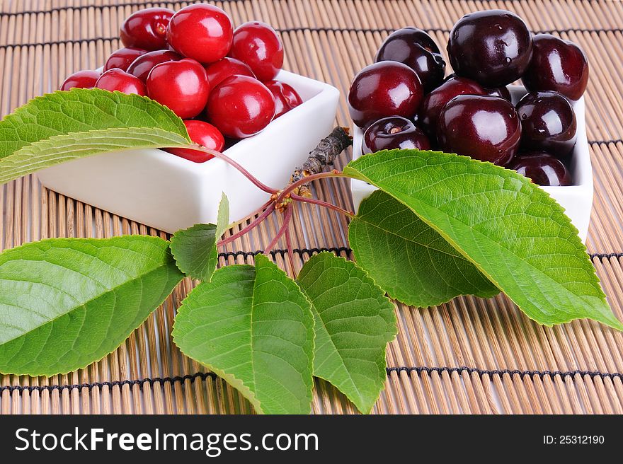 Cherries in ware on a straw napkin. Cherries in ware on a straw napkin