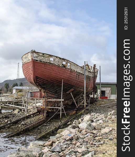 Old rusty wood ship on shore