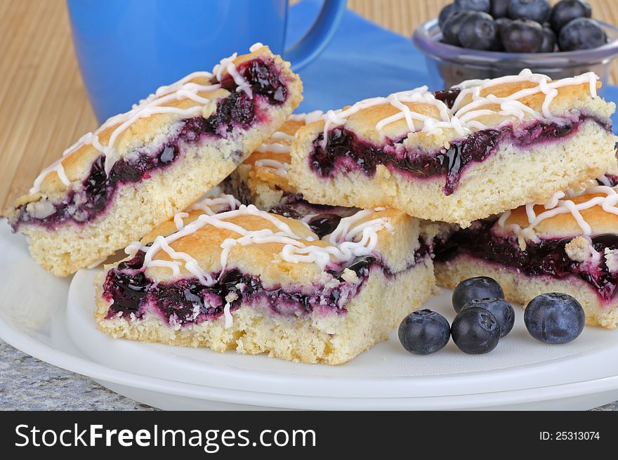 Plate of stacked blueberry bars and berries. Plate of stacked blueberry bars and berries