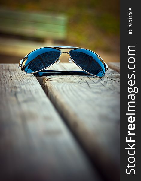 Sunglasses photographed on a table in park