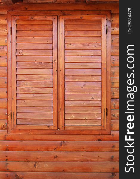 Closed wooden window on wood wall