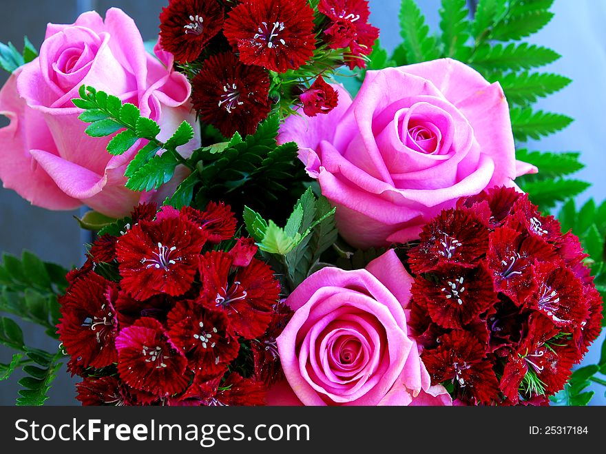 Pink rose and red flowers