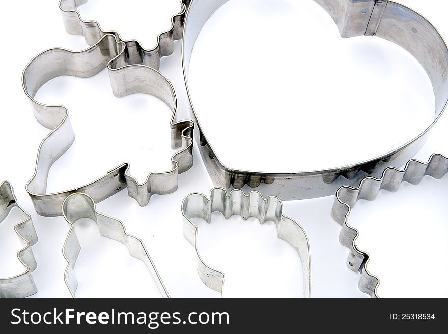 Many metal cookie cutters on white. Many metal cookie cutters on white