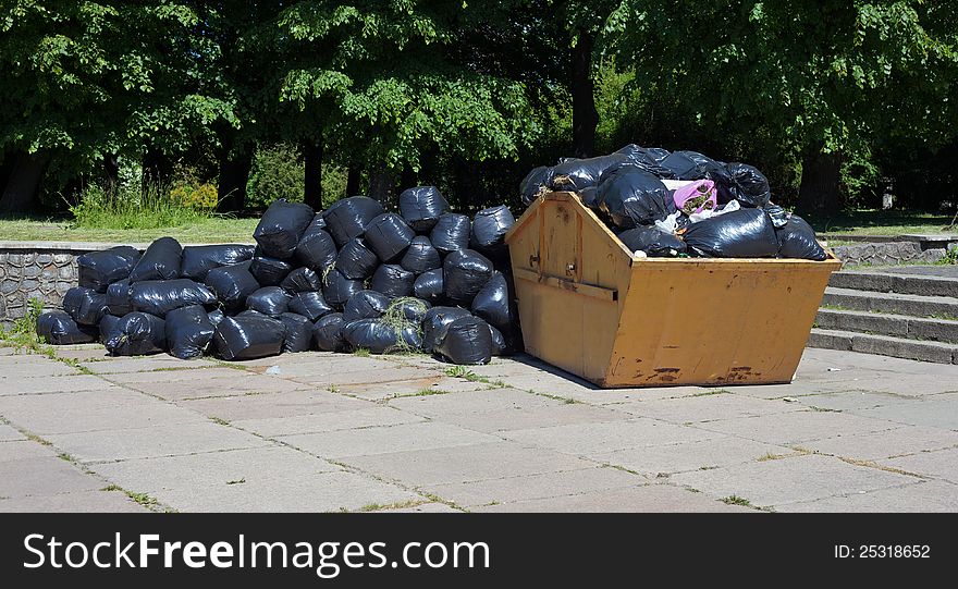 Container with garbage on the street in the city