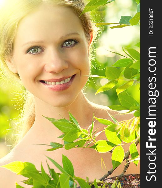 Face of beauty girl in nature with green leaves
