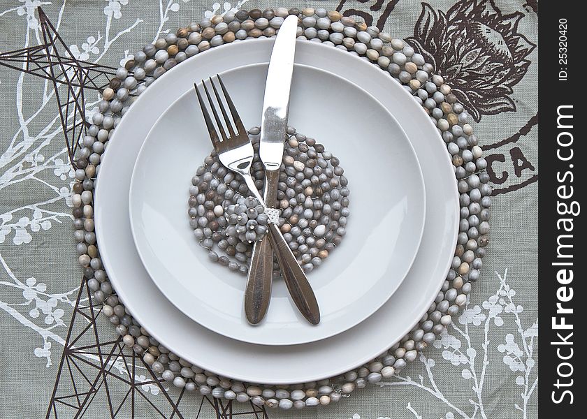 Table place setting with beaded place mats made by African craftsmen. Table place setting with beaded place mats made by African craftsmen