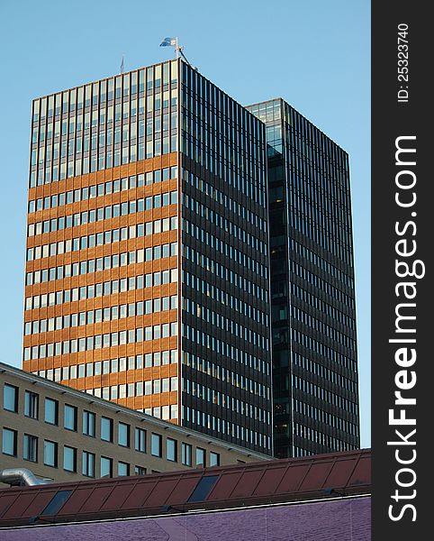 The two towers of Postgirobygget in the center of Oslo, Norway, glows in the evening sun against a blue sky. The two towers of Postgirobygget in the center of Oslo, Norway, glows in the evening sun against a blue sky