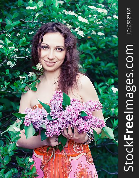 Young woman with lilac flowers