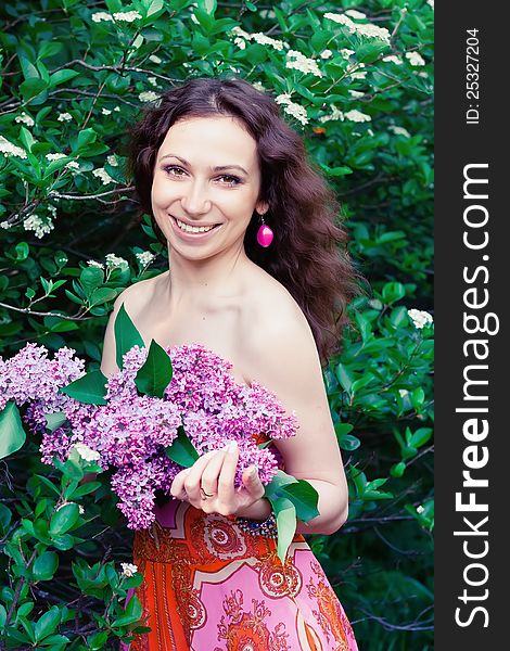 Young woman with lilac flowers