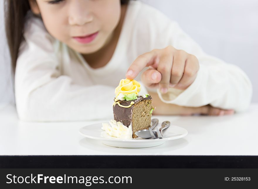 The girl stared cake for overcome by a temptation to eat a slice of a sweet cake