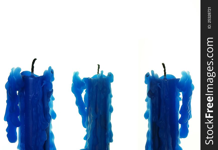 Three blue candles against white background