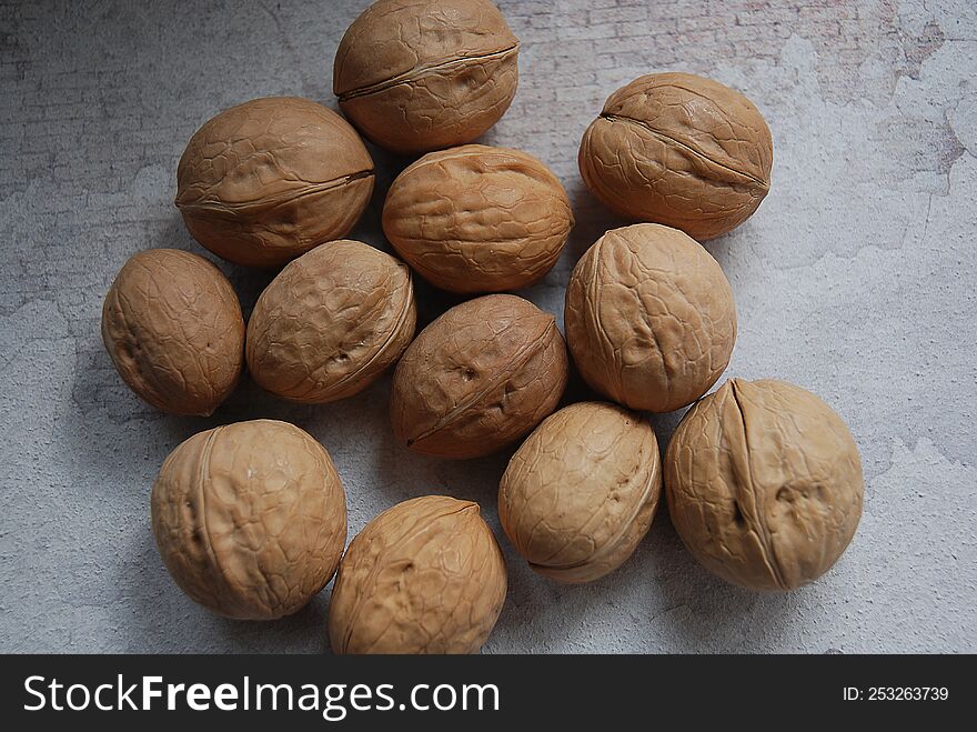 Walnuts with shells. Background of fresh walnuts.