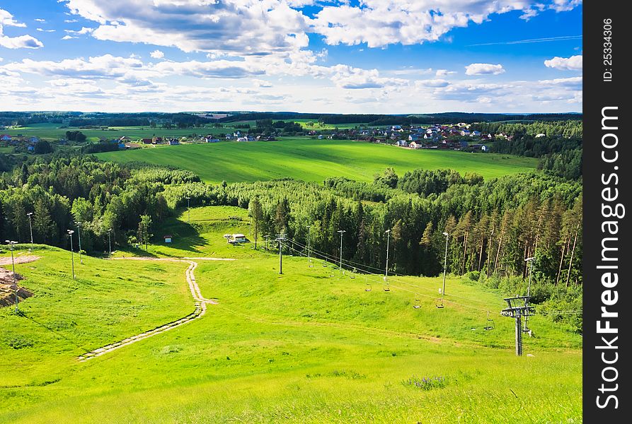 With mountains, pastures, and footpath. With mountains, pastures, and footpath