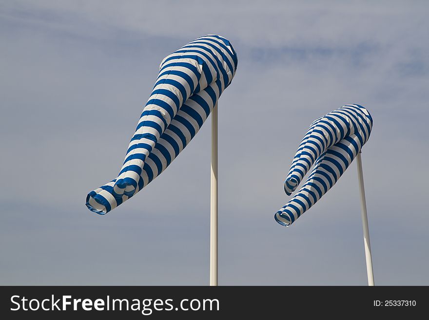 Blue and white windsock blows against a blue sky. Blue and white windsock blows against a blue sky