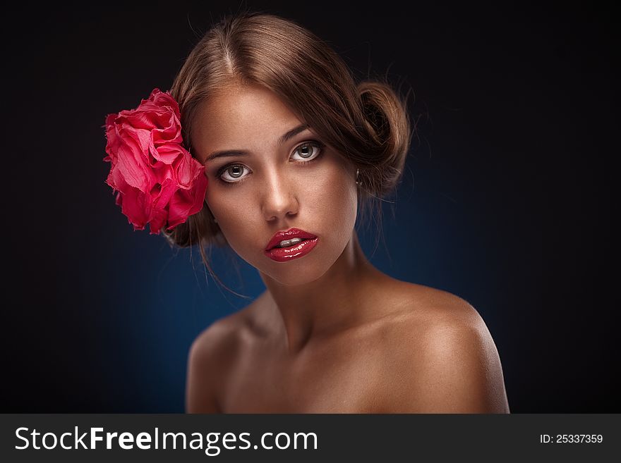 Beauty Face Of The Young Woman With Flower