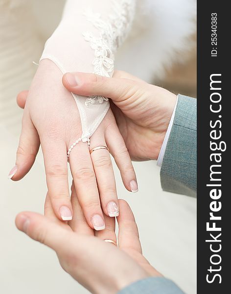 Man holding a fragile bride's hand in his strong arms, dof, close-up. Man holding a fragile bride's hand in his strong arms, dof, close-up