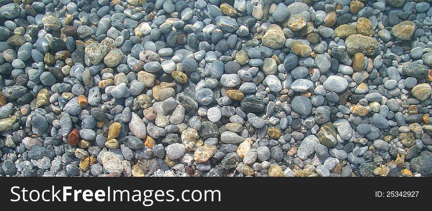 Pebbles in the sea water. Pebbles in the sea water