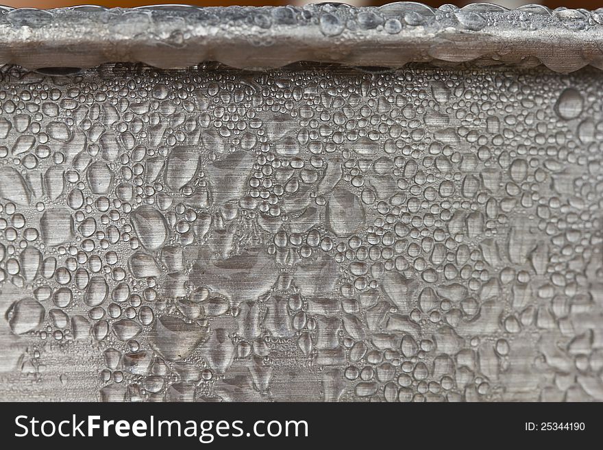 Water droplets, condensation on metallic ice bucket surface