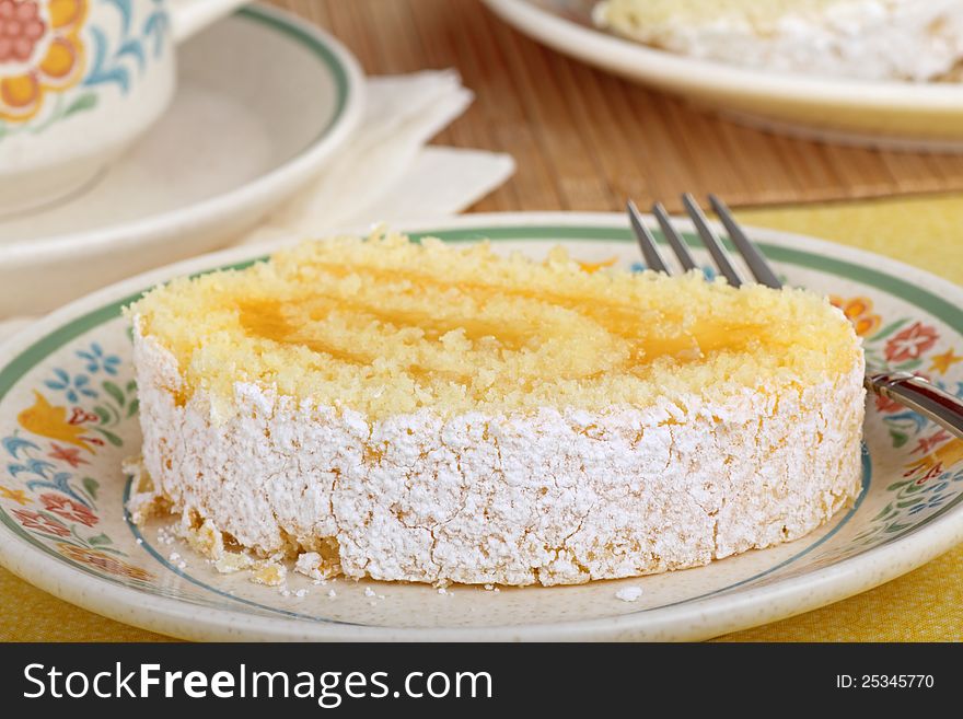 Slice of lemon role cake on a plate. Slice of lemon role cake on a plate