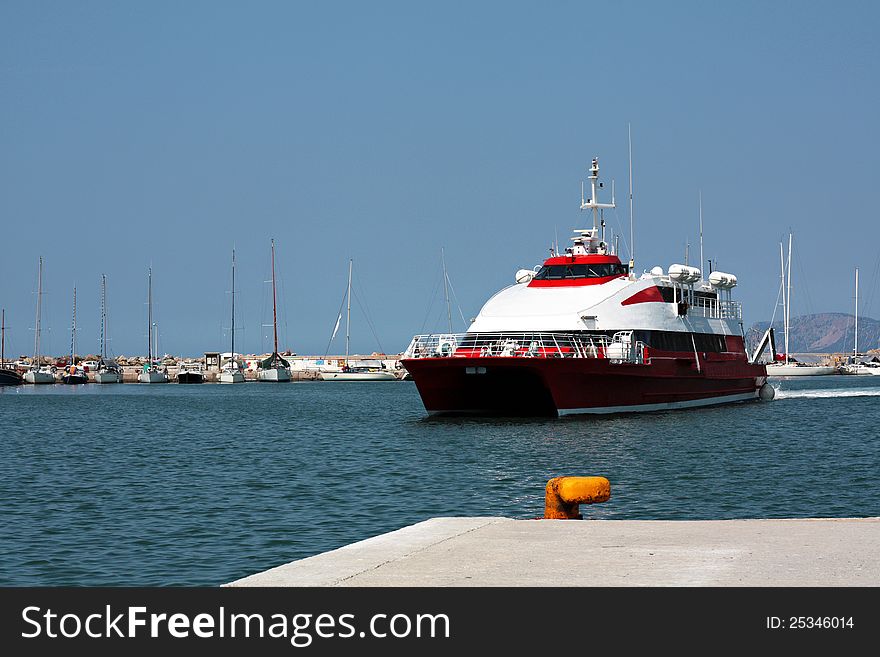 A red high speed dolphin arrive to the port of Skopelos at Greece.