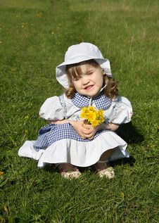 Little Girl With Yellow Dandelions Sits On Grass Royalty Free Stock Photography Little Girl With Yellow Dandelions Sits On Grass Royalty Free Stock Photography