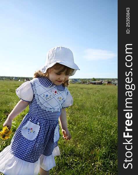 Happy Little Girl Walks On Green Field