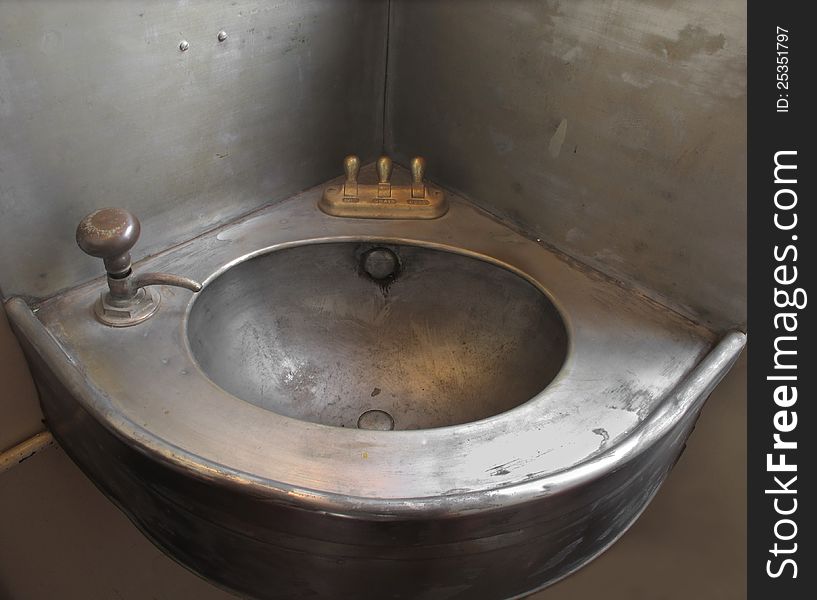 Old corner single metal sink.