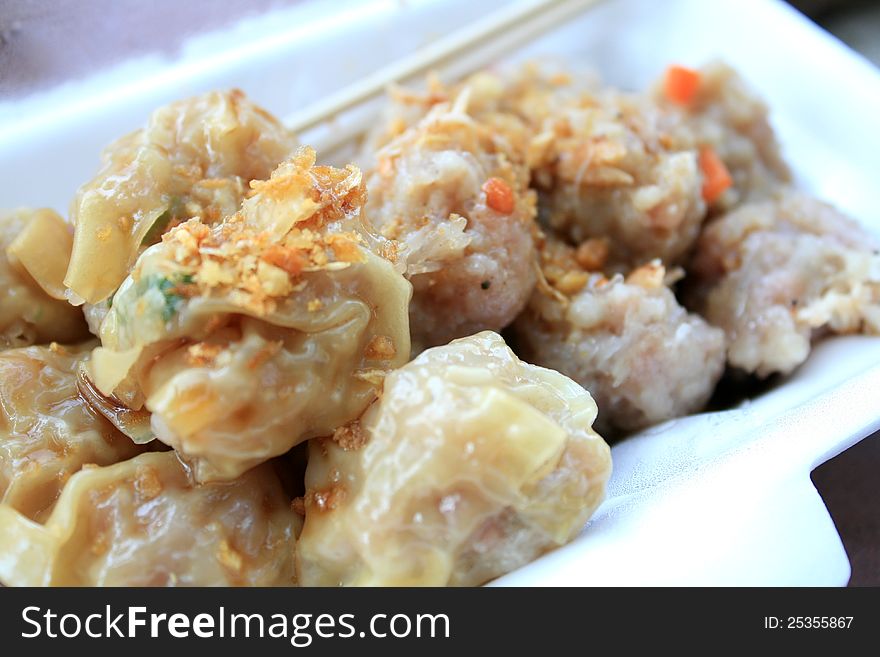 Chinese steamed dumpling, Thai morning snack appetizer, Dim-sum, made from crab, pork, shrimp, prawn with fried garlic on top