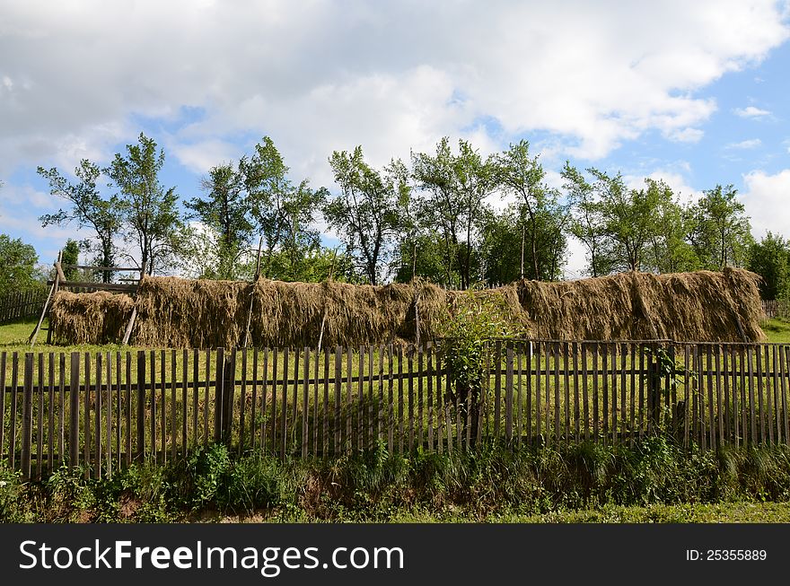 Wooden fence bounding generic transylvania household with haycock. Wooden fence bounding generic transylvania household with haycock